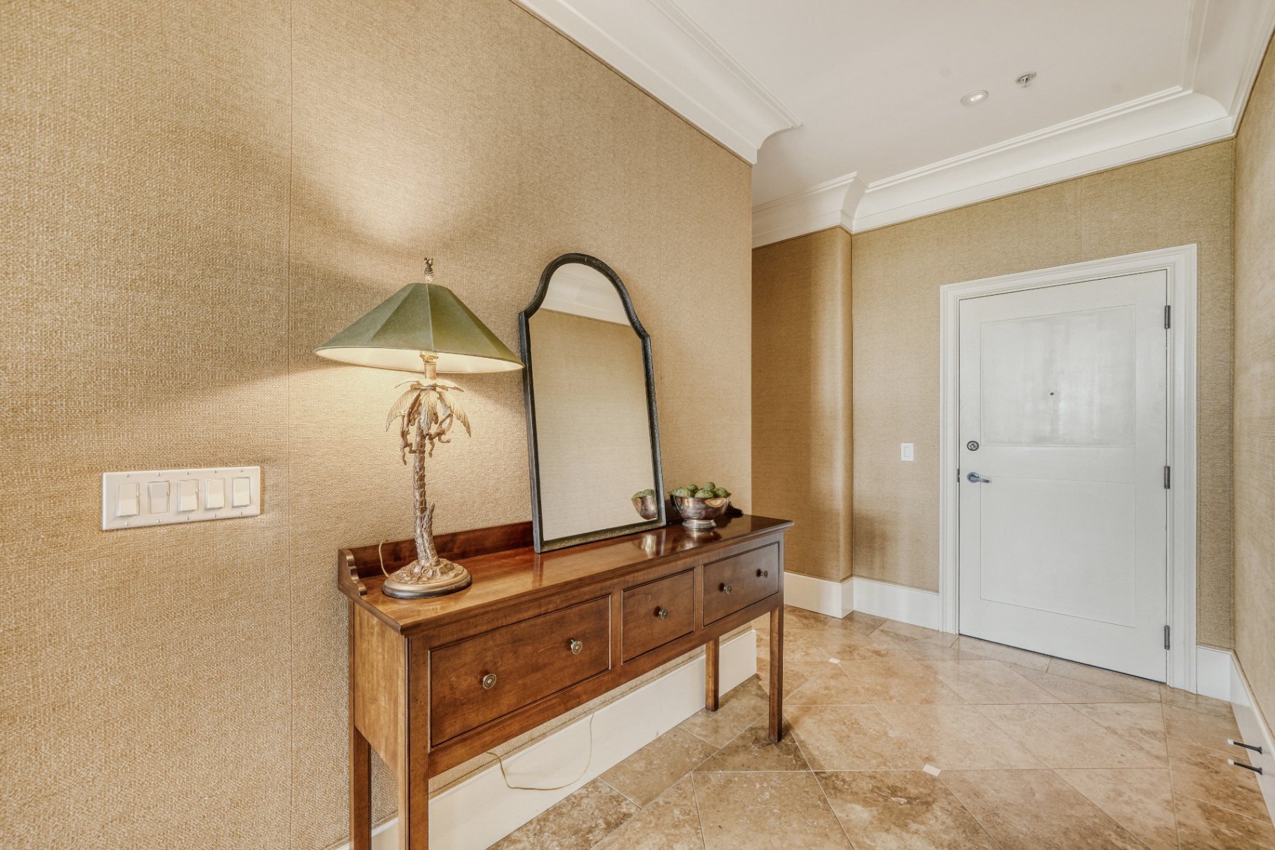 Entry foyer with console, mirror, and front door