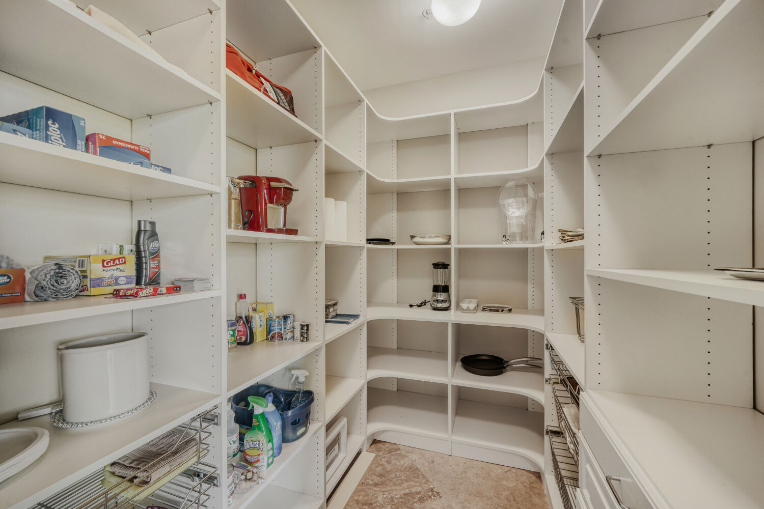 Oversized walk-in pantry with custom cabinetry