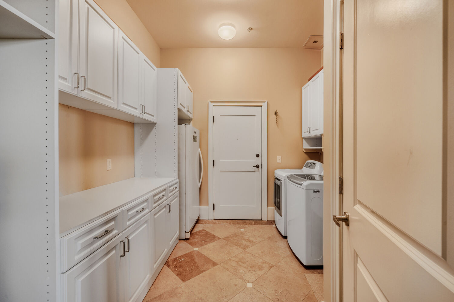 Private service vestibule and laundry suite with concierge delivery access